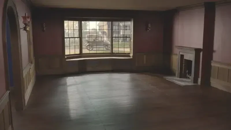 here szenenbild ein leeres wohnzimmer, mit blick auf die straße und ein altes auto