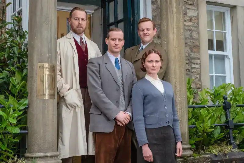 Der Doktor und das liebe Vieh Staffel 1 Szene: Vier Personen im Vintage-Stil vor einem Gebäude